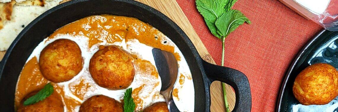 Malai Kofta met romige saus en krokante balletjes, perfect voor een smakelijk vegetarisch gerecht.